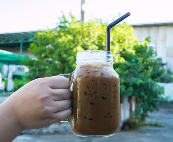 Close-up of hand holding drink