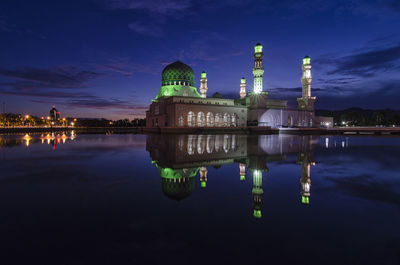 Reflection of building in water at night