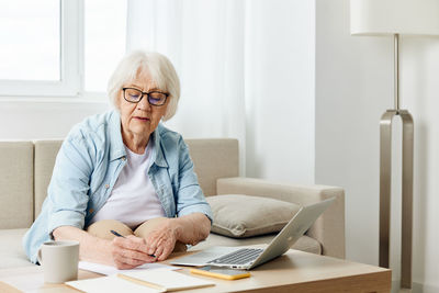 Young woman using laptop at home