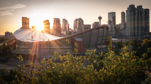 Modern buildings against sky during sunset