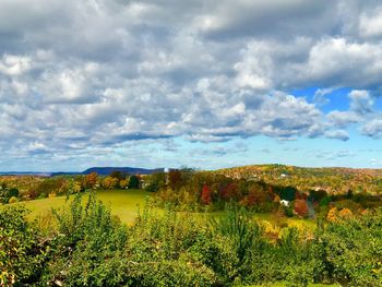 Scenic view of field against cloudy sky