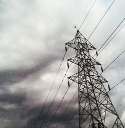 Low angle view of electricity pylon against sky