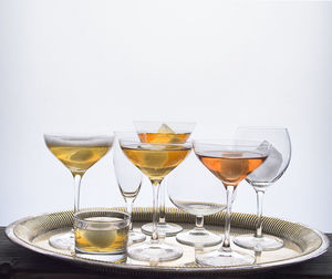 Close-up of wineglass on table against white background