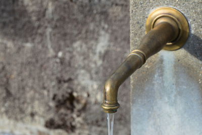 Close-up of rusty pipe against wall