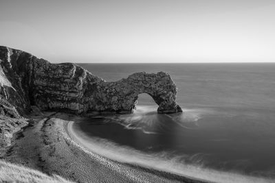 Long exposure of the calm sea at durdle door at dusk