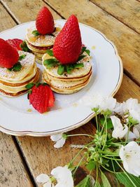 High angle view of strawberry pancakes served on table