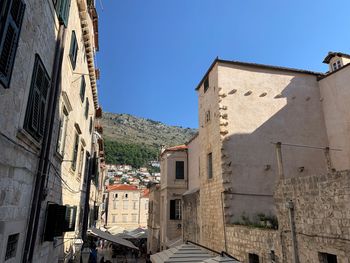 Buildings in town against clear blue sky