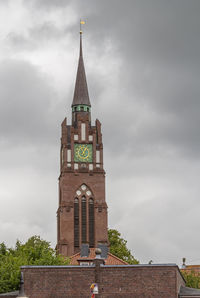 Low angle view of clock tower against sky