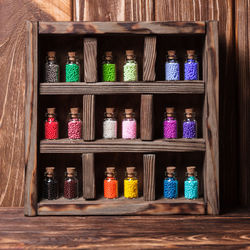 Multi colored bottles in shelf at market stall