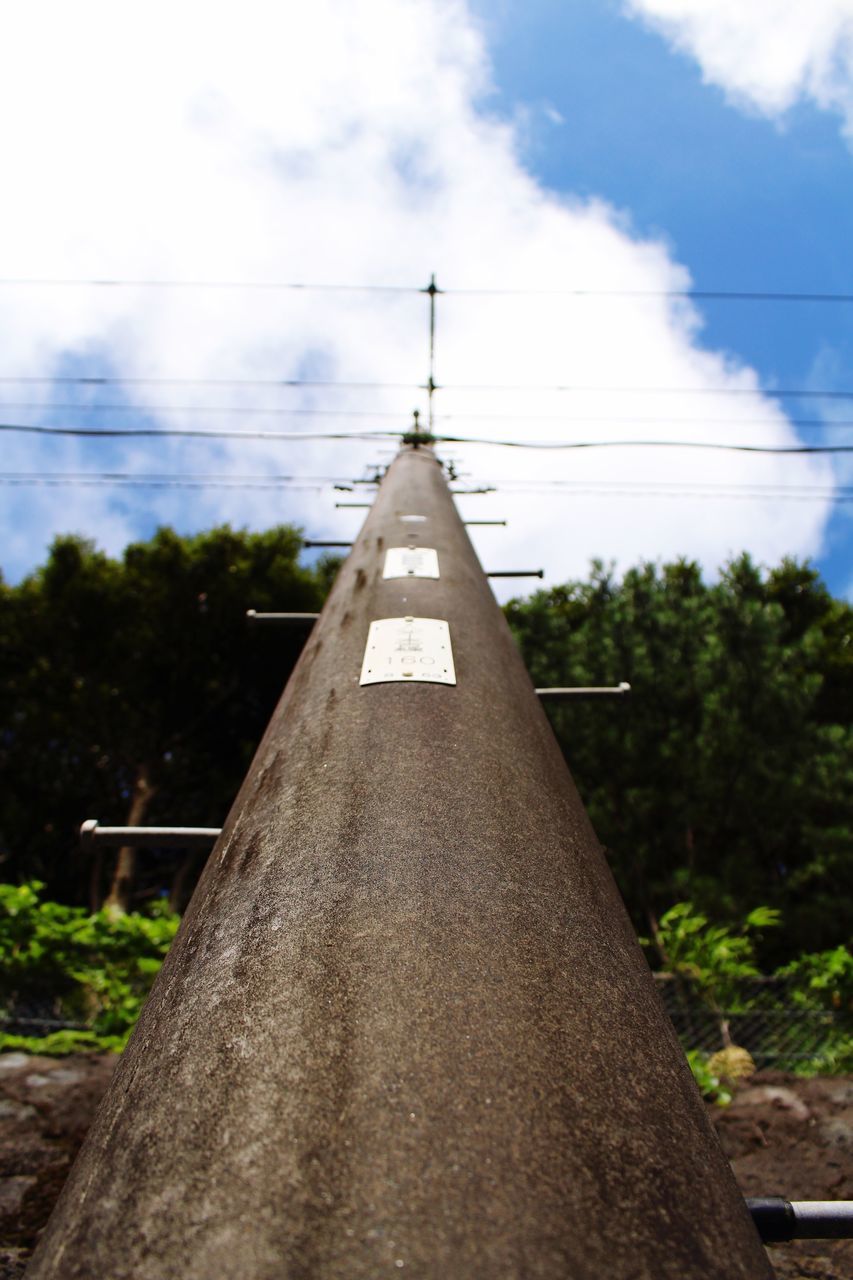 sky, tree, low angle view, power line, built structure, fuel and power generation, architecture, cloud - sky, electricity, cable, building exterior, technology, cloud, electricity pylon, power supply, connection, cloudy, outdoors, day, no people