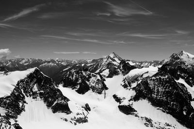 Scenic view of snow covered mountains against sky