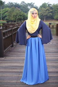 Beautiful woman in hijab standing on boardwalk