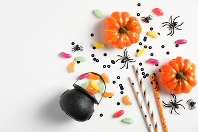 High angle view of orange berries on white background