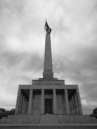 Low angle view of historical building against cloudy sky