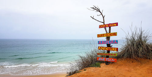 View of text on beach against sky