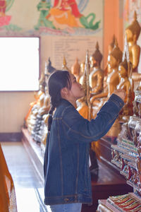 Side view of woman looking at camera