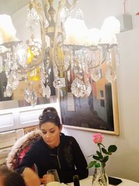 Young woman sitting by window in restaurant