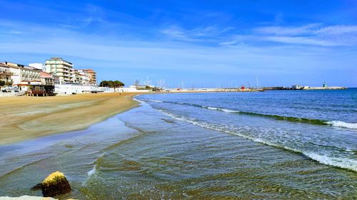 Scenic view of beach against sky in city