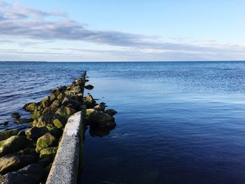 Scenic view of sea against cloudy sky