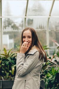 Portrait of beautiful young woman standing outdoors