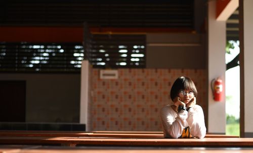 Portrait of young woman using smart phone at home