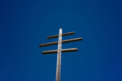 Low angle view of wooden structure against clear blue sky