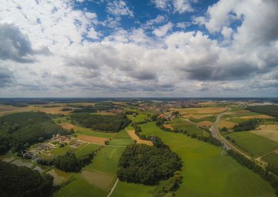 Scenic view of agricultural field against sky