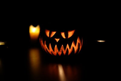 Close-up of illuminated pumpkin against black background