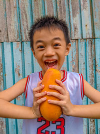 Portrait of happy boy holding food