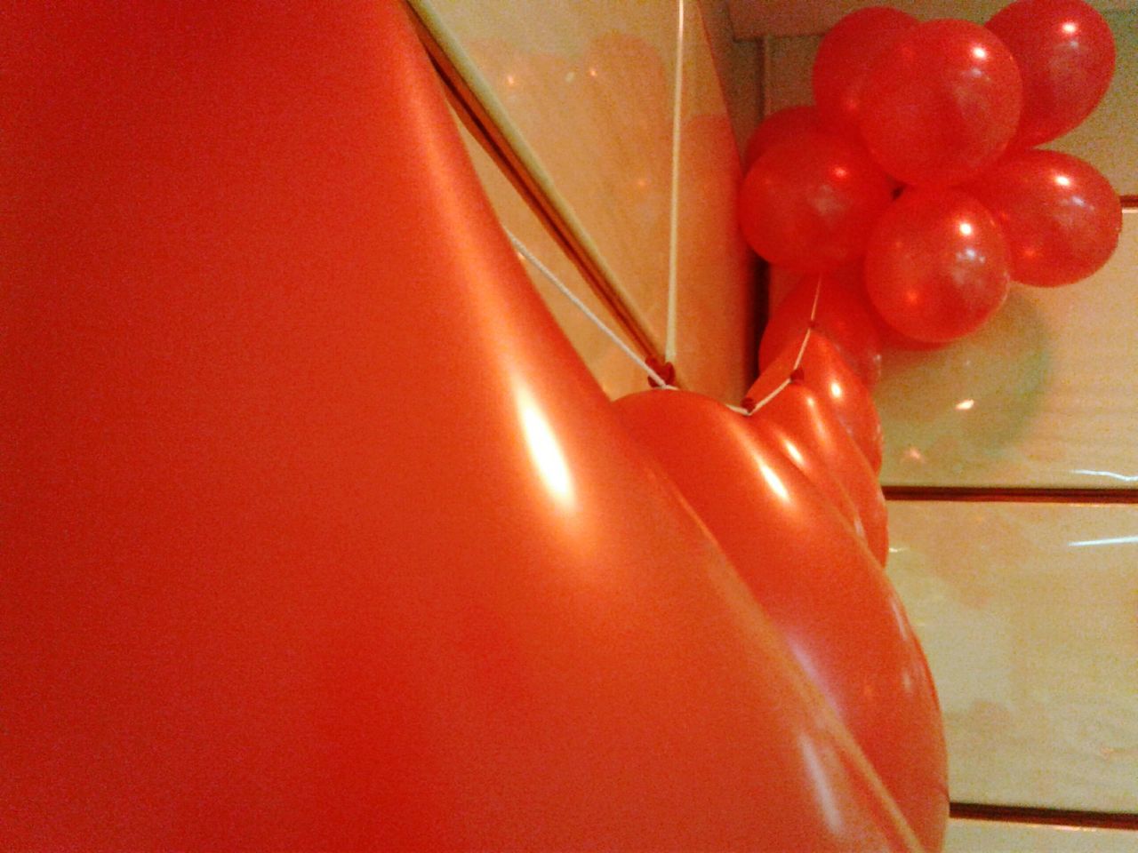 indoors, red, still life, close-up, no people, single object, part of, wall - building feature, table, high angle view, shiny, orange color, hanging, home interior, plastic, metal, studio shot, cropped, detail, directly above