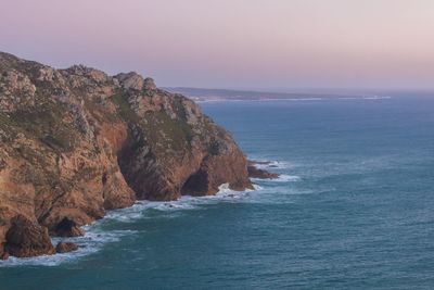 Scenic view of sea and rock formation against sky