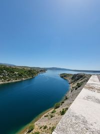 Scenic view of sea against clear blue sky