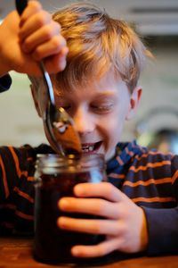 Smiling boy having food at home