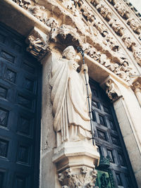 Low angle view of statue against historic building