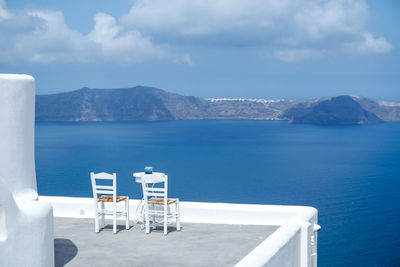 Scenic view of sea by mountains against sky