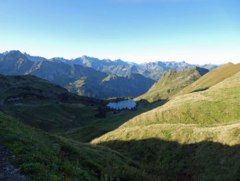 Scenic view of mountains against clear blue sky