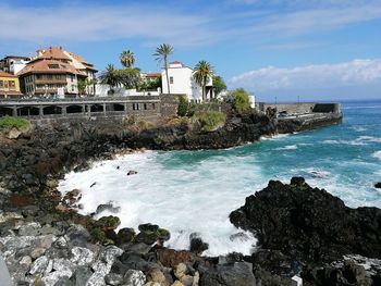 View of sea with buildings in background