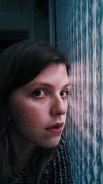 Close-up of woman by window