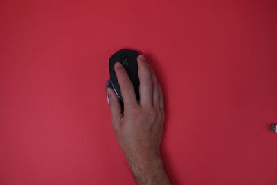 Close-up of hand against pink background