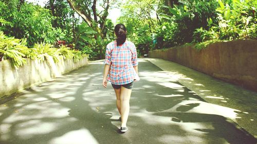 Full length of woman walking on footpath