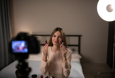 Portrait of woman sitting at home