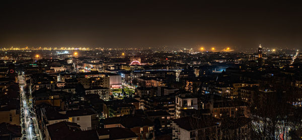 High angle view of city lit up at night