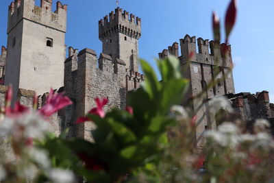 Low angle view of historic building in sirmione against sky