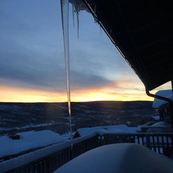 Scenic view of snowcapped mountains against sky during sunset