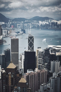 High angle view of buildings by sea against sky