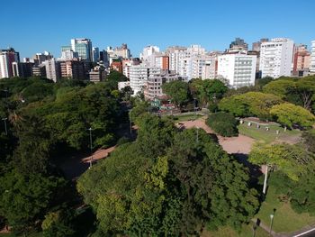 High angle view of trees and buildings against sky