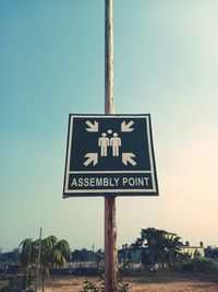 Low angle view of road sign against clear sky