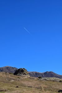 Scenic view of mountains against clear blue sky
