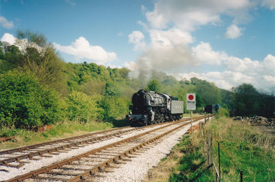 Train on railroad tracks against sky