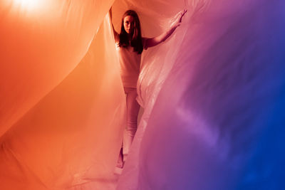 Young woman trying to escape from plastic maze during covid-19